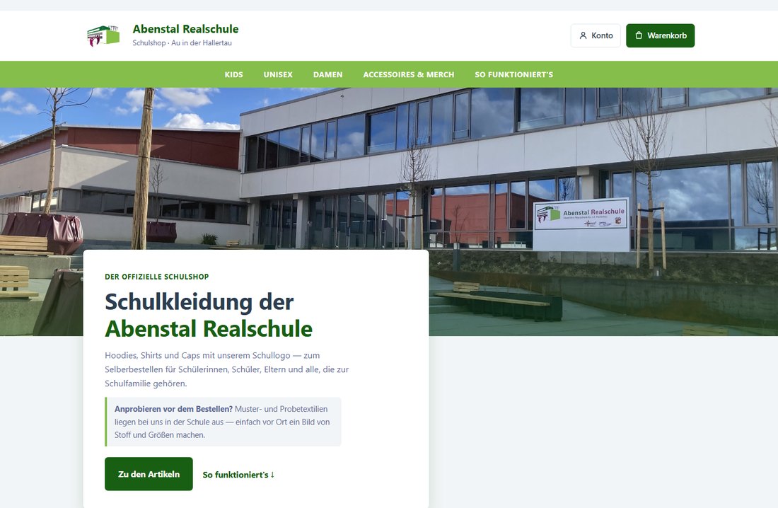 Startseite des Schulshops der Abenstal Realschule: grüne Navigationsleiste, Schulhaus-Foto, Schullogo